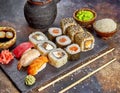 Sushi platter of rolls, maki, nigiri, on dark stone board with sticks Royalty Free Stock Photo
