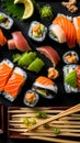 Sushi platter with soy sauce, ginger and wasabi on a black background