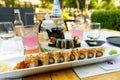 sushi restaurant. Outside table set up and dish presentation. Raw salmon sushi plate with drinks. Royalty Free Stock Photo