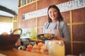 Sushi restaurant, portrait and female waitress with a plate for serving a food order with a smile. Happy, lunch and Royalty Free Stock Photo