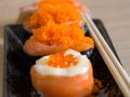 Sushi rice wrapped in seaweed and shrimp egg with chopstick Royalty Free Stock Photo