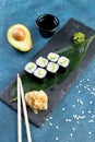 Sushi roll with avocado, classic Japanese sushi. Traditional Japanese food with maki. Delicious pieces of sushi