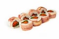 Sushi roll with bacon and salmon on a white background, ingredients seared bacon, salmon, green onions, flying fish roe, Iceberg Royalty Free Stock Photo