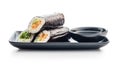Sushi Roll on Black Plate With bowl of soy sauce Royalty Free Stock Photo