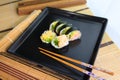 Sushi roll on a black plate ready to be served Royalty Free Stock Photo