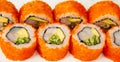 Sushi roll California roll on a white background, ingredients Shrimp, cucumber, avocado, flying fish roe, rice, nori Royalty Free Stock Photo