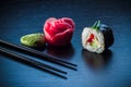 Sushi roll with caviar, ginger, wassabi and chopsticks on black tableboard. Japanese food concept. Royalty Free Stock Photo