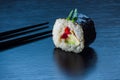 Sushi roll and chopsticks on black tableboard. Japanese food concept. Royalty Free Stock Photo