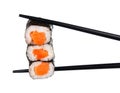 Sushi roll in chopsticks Isolated Royalty Free Stock Photo