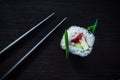 Sushi roll and chopsticks top view on black tableboard. Japanese food concept. Royalty Free Stock Photo