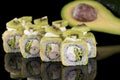 Sushi Roll with crab meat, kiwi and avocado over black backgrou Royalty Free Stock Photo