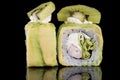 Sushi Roll with crab meat, kiwi and avocado over black backgrou Royalty Free Stock Photo