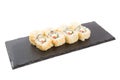 Sushi Roll with cream cheese above and Fresh fish and Avocado on a slate slab on white background