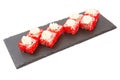 Sushi Roll with cream cheese above and Fresh fish and Avocado on a slate slab on white background