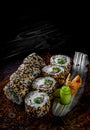 Sushi roll with cream cheese, cucumber and eel in plate on black wooden table Royalty Free Stock Photo