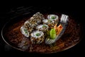 Sushi roll with cream cheese, cucumber and eel in plate on black wooden table Royalty Free Stock Photo