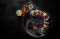 Sushi roll with cream cheese, cucumber and eel in plate on black wooden table Royalty Free Stock Photo