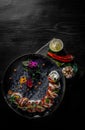 Sushi roll with cream cheese, cucumber and eel in plate on black wooden table Royalty Free Stock Photo