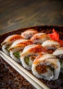 Sushi roll with cream cheese and eel in plate on wooden table Royalty Free Stock Photo