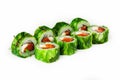 Sushi roll green with chuka salad on a white plate, classic Japanese sushi. Traditional Japanese food with maki. Delicious pieces