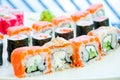 Sushi roll japanese food in restaurant. California Sushi roll set with salmon, vegetables, red flying fish roe. Sushi Royalty Free Stock Photo