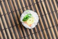 Sushi roll lie on a bamboo straw serwing mat. Traditional Asian food. Top view. Flat lay minimalism shot with copy space