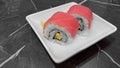 Sushi roll Maguro with tuna, cucumber, egg, seaweed and rice, serving on white plate. Traditional Japanese food