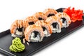 Sushi Roll - Maki Sushi made of grilled salmon, black caviar and cream cheese on black plate isolated over white background Royalty Free Stock Photo