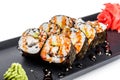 Sushi Roll - Maki Sushi made of smoked eel, Crab meat, avocado on black plate isolated over white background. Royalty Free Stock Photo