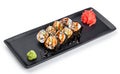 Sushi Roll - Maki Sushi made of smoked eel, Crab meat, avocado on black plate isolated over white background. Royalty Free Stock Photo