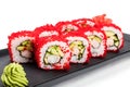 Sushi Roll - Maki Sushi with red caviar, Crab meat, cucumber, avocado on black plate over white background Royalty Free Stock Photo