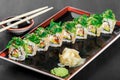 Sushi Roll - Maki Sushi with sea kale, Crab meat, avocado, cream cheese and sesame on dark wooden background Royalty Free Stock Photo