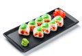 Sushi Roll - Maki Sushi with green and red caviar, Crab meat, salmon and cream cheese on black plate Royalty Free Stock Photo