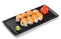 Sushi Roll - Maki Sushi made of salmon, avocado and cream cheese on black plate isolated over white background. Royalty Free Stock Photo