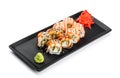 Sushi Roll - Maki Sushi made of salmon, smoked eel, cucumber, avocado and cream cheese on black plate Royalty Free Stock Photo