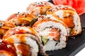 Sushi Roll - Maki Sushi made of salmon, smoked eel, cucumber, avocado and cream cheese on black plate Royalty Free Stock Photo