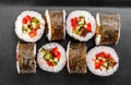 Sushi Roll - Maki Sushi with pepper, cucumber, tomato and cabbage on black plate Royalty Free Stock Photo