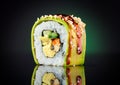 Sushi roll over black background. Sushi roll with eel, tofu, vegetables and avocado closeup