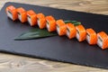 Sushi roll (Philadelphia) with salmon smoked eel avocado cream cheese on black background. Sushi menu. Japanese food Royalty Free Stock Photo