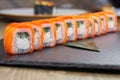 Sushi roll (Philadelphia) with salmon smoked eel avocado cream cheese on black background. Sushi menu. Japanese food Royalty Free Stock Photo