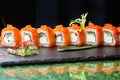 Sushi roll (Philadelphia) with salmon smoked eel avocado cream cheese on black background. Sushi menu. Japanese food Royalty Free Stock Photo