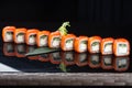 Sushi roll (Philadelphia) with salmon smoked eel avocado cream cheese on black background. Sushi menu. Japanese food Royalty Free Stock Photo