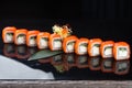 Sushi roll (Philadelphia) with salmon smoked eel avocado cream cheese on black background. Sushi menu. Japanese food Royalty Free Stock Photo