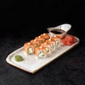 Sushi roll-Philadelphia with salmon, smoked eel, avocado, cream cheese on black background. Sushi menu. Japanese food Royalty Free Stock Photo