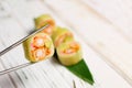 Sushi Roll piece without rice with avocado, cream cheese, crunchy tempura shrimp wrapped in cucumber daikon Royalty Free Stock Photo