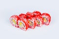 Sushi roll in red flying fish roe Tobiko caviar served on gray background with Unagi eel, mango, avocado and Philadelphia cheese Royalty Free Stock Photo