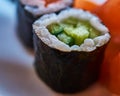 Sushi roll of rice wrapped with seaweed and a filling of green cucumber, maki