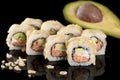 Sushi Roll with salmon and avocado over black background with r