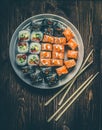 Sushi roll with salmon, cucumber, avocado, red caviar with chopsticks. Sushi menu. Japanese food. Close up, on bamboo Royalty Free Stock Photo