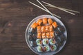 Sushi roll with salmon, cucumber, avocado, red caviar with chopsticks. Sushi menu. Japanese food. Close up, on bamboo Royalty Free Stock Photo